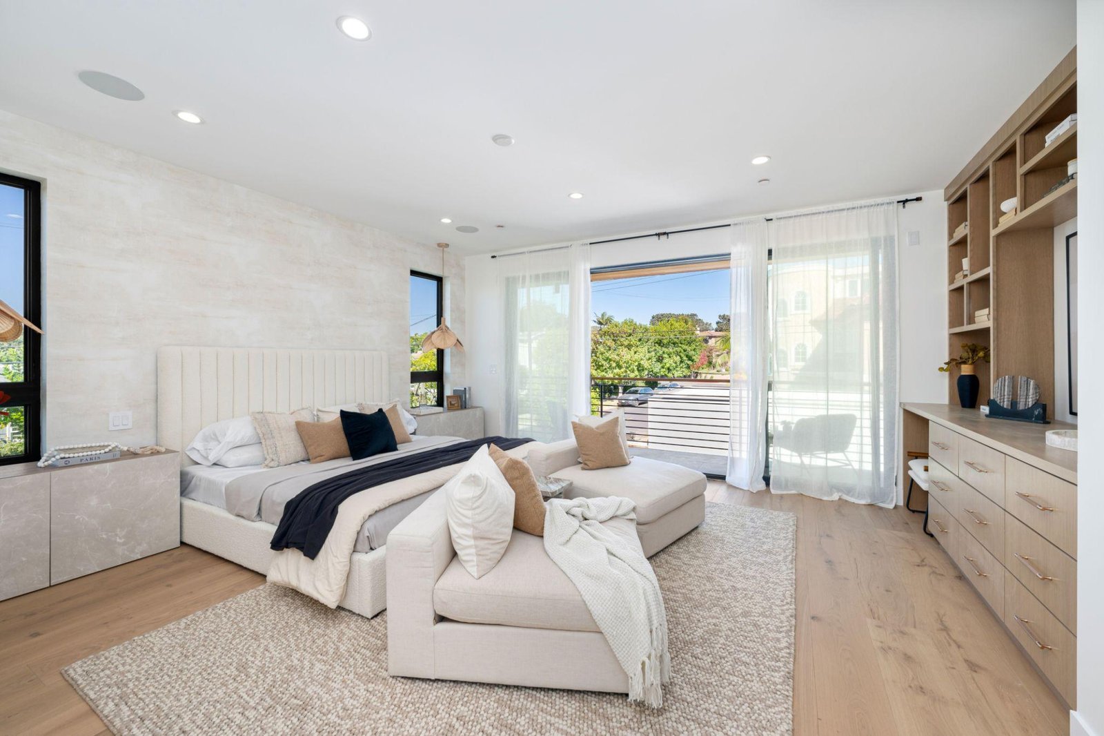 Modern bedroom with neutral tones and natural light.