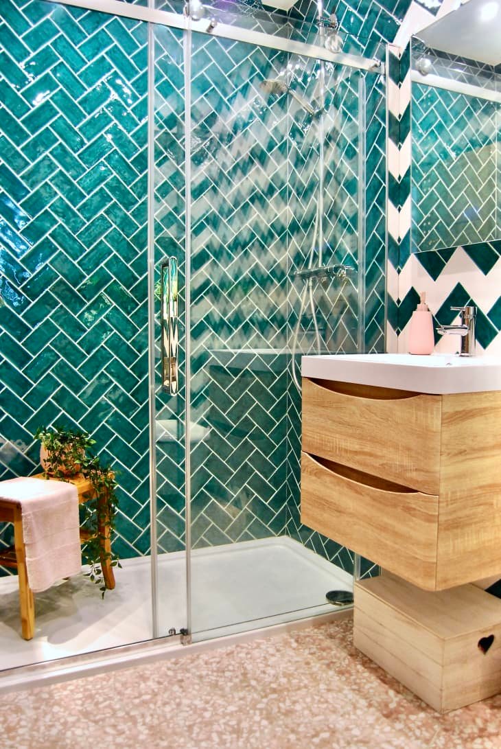 Aqua colored subway tiles in a bathroom.