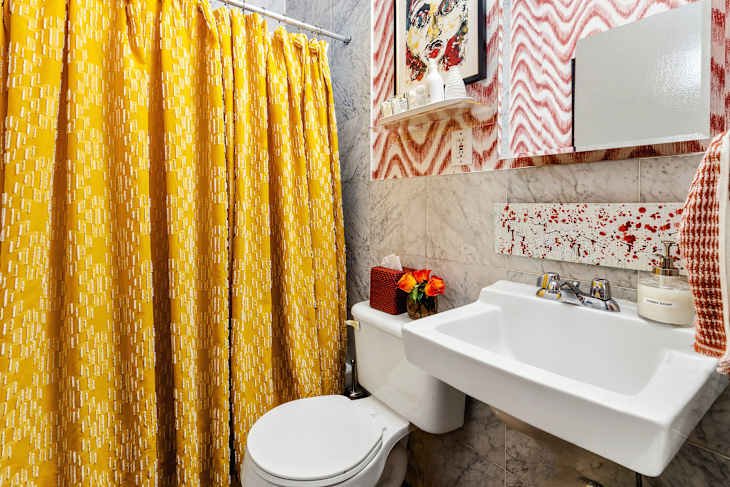 Yellow shower curtain in bathroom.